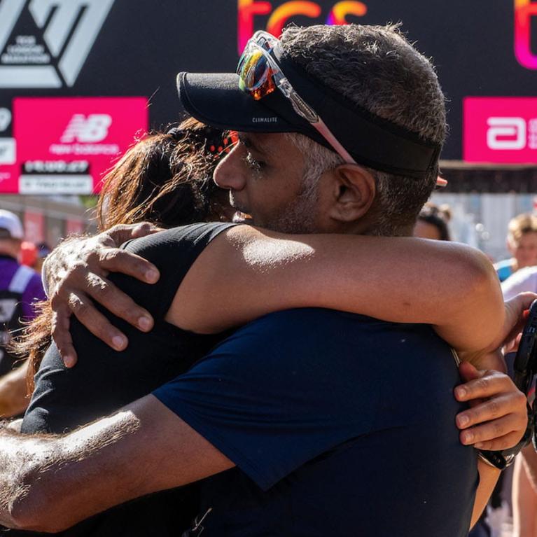 Runners hug at the finish of 2022 TCS London Marathon