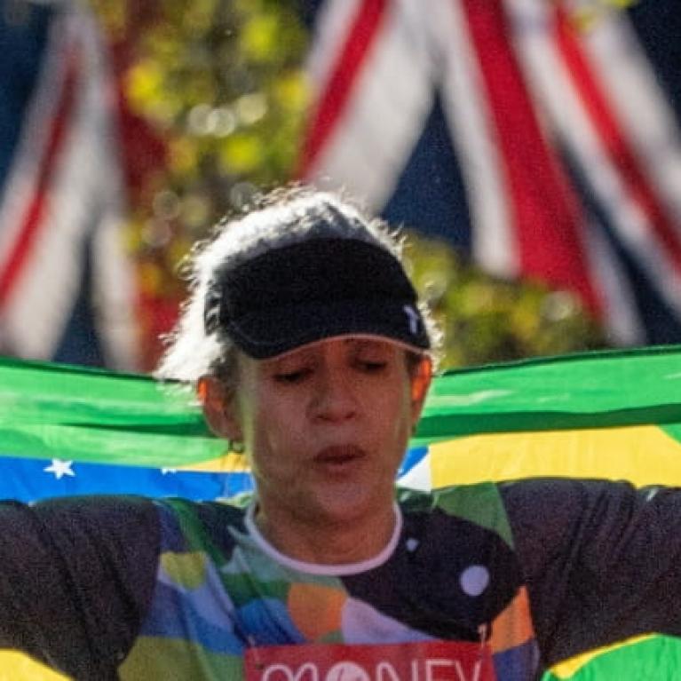 A mass runner crosses the finish line