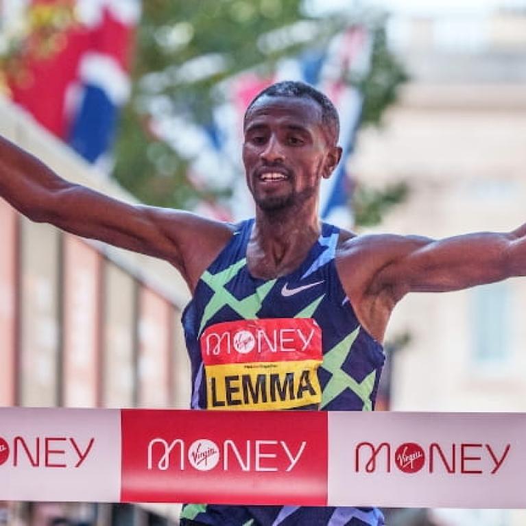 Sisay Lemma (ETH) celebrates as he crosses the finish line to win the Elite Men's Race