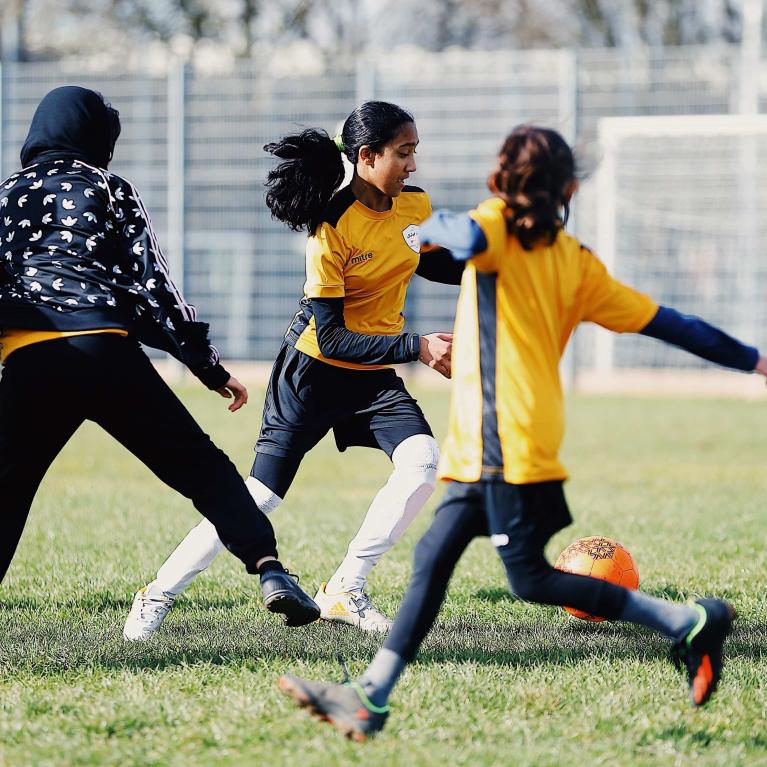 A group of girls playing football