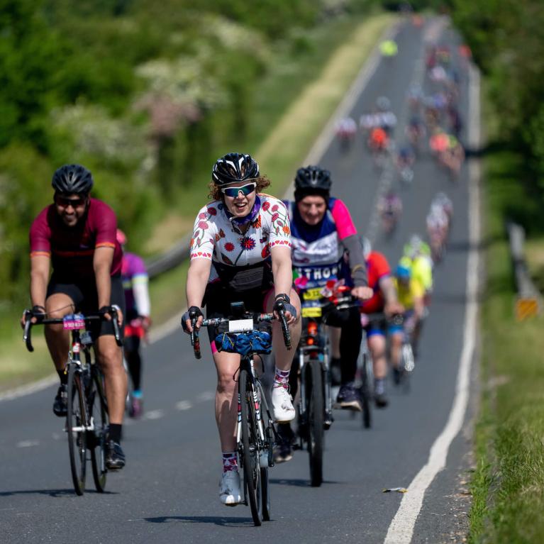 A group of cyclists on a country road