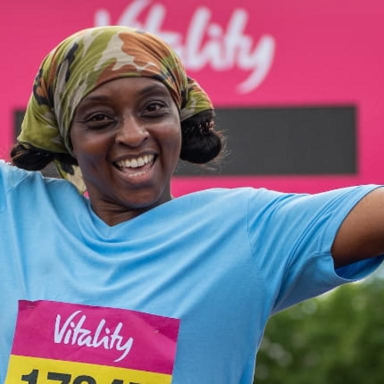 Runners celebrate after crossing the finish line of The Vitality London 10,000