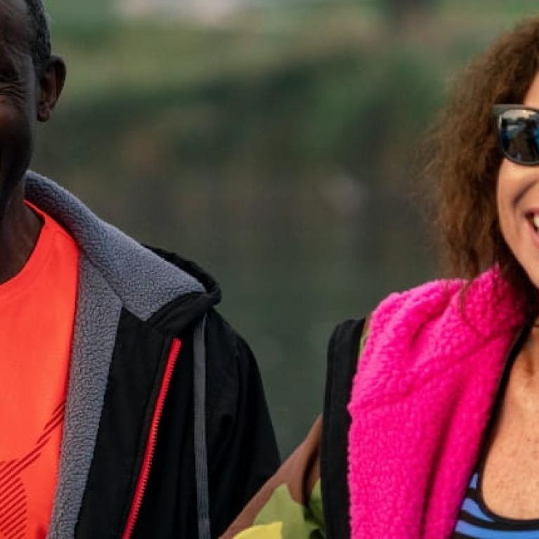 Linford Christie, Jamaican-born British sprinting legend and 1992 Olympic 100m gold medallist, smiles with Hollywood star Minnie Driver, before taking part in the half-mile swim