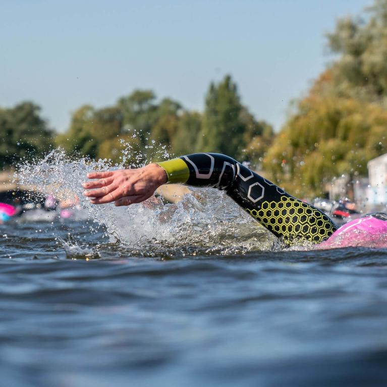 A swimmer submerged, swims through water