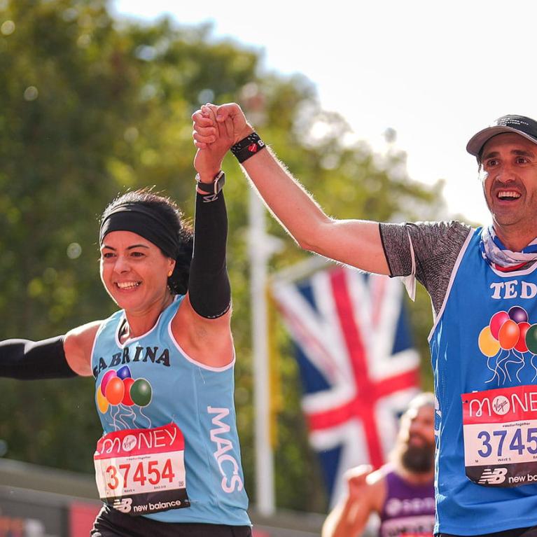 Runners on The Mall celebrate as they approach the Finish Line