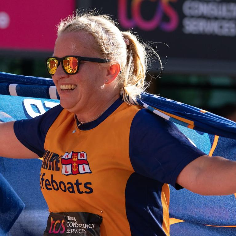 A participant completes the TCS London Marathon for charity