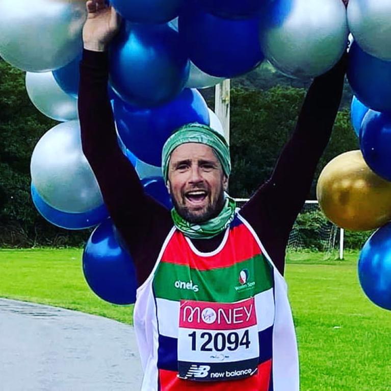 A virtual Virgin Money London Marathon runner celebrates after completing his run