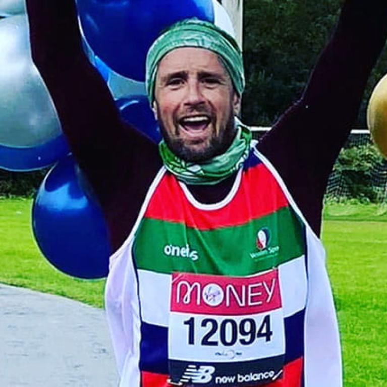 A virtual TCS London Marathon runner celebrates after completing his run