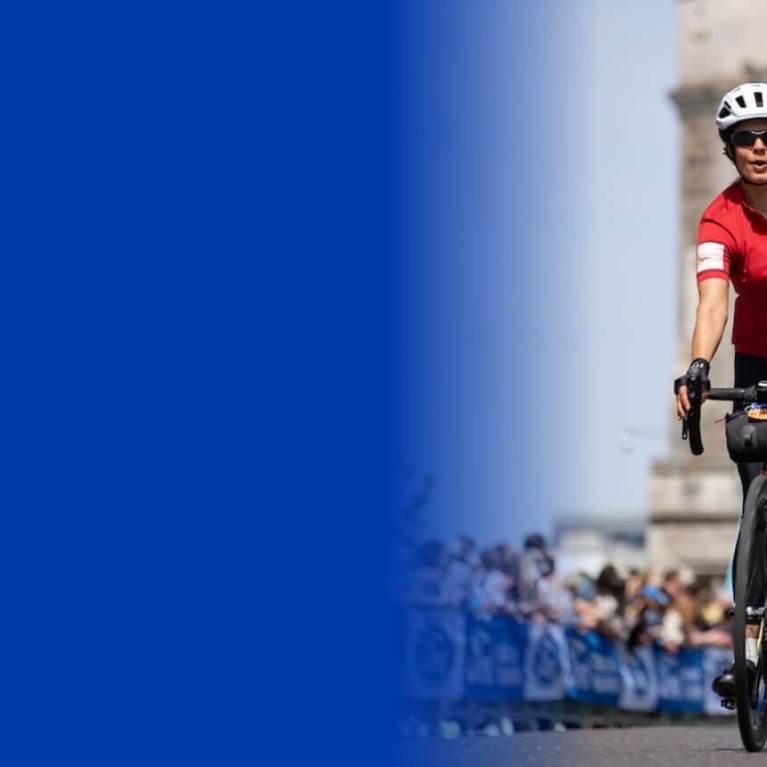 A woman celebrates on Tower Bridge after completing her Ford RideLondon challenge