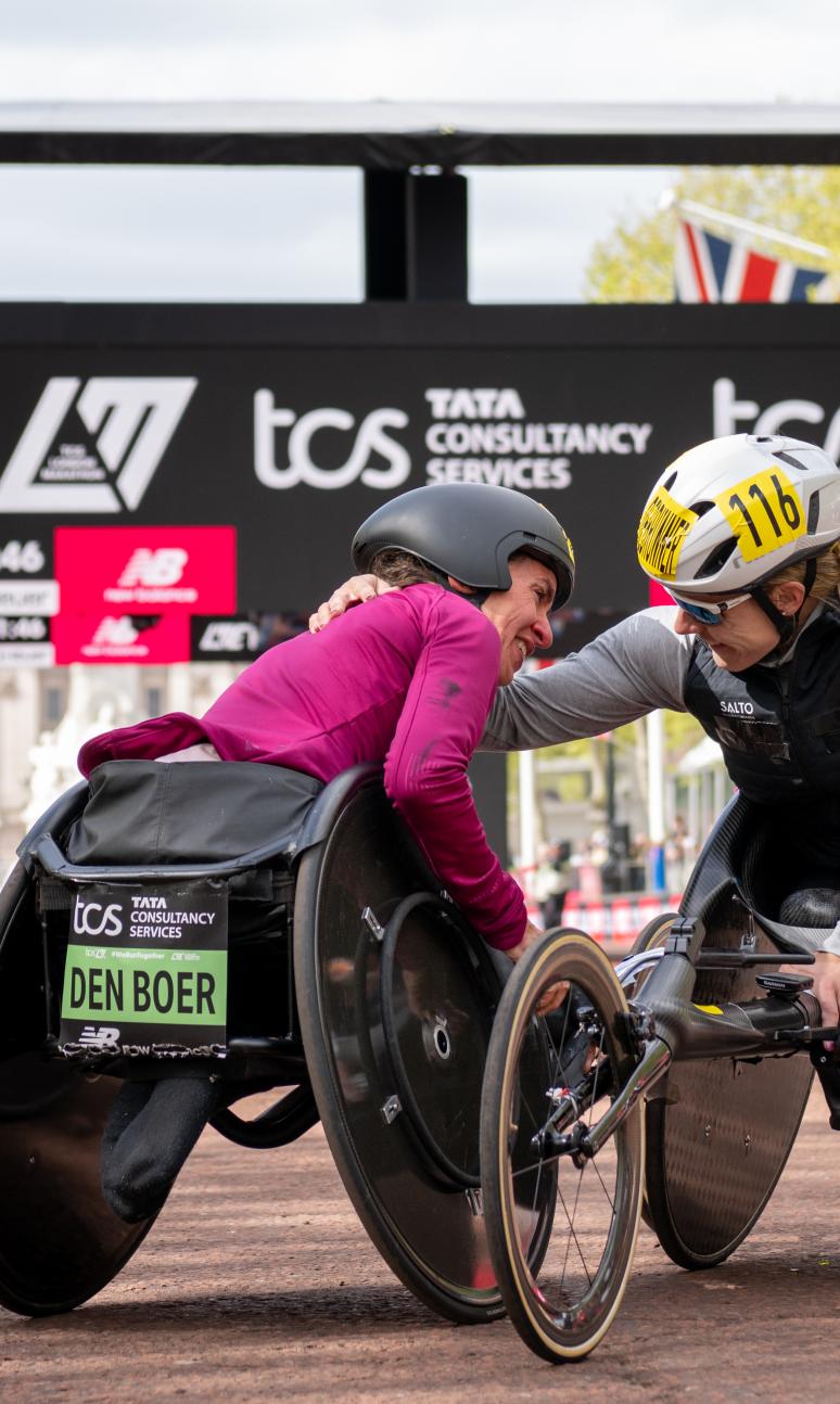 Nikita den Boer embraces Catherine Debrunner at the Finish Line on The Mall after completing the Elite Women’s Wheelchair Race