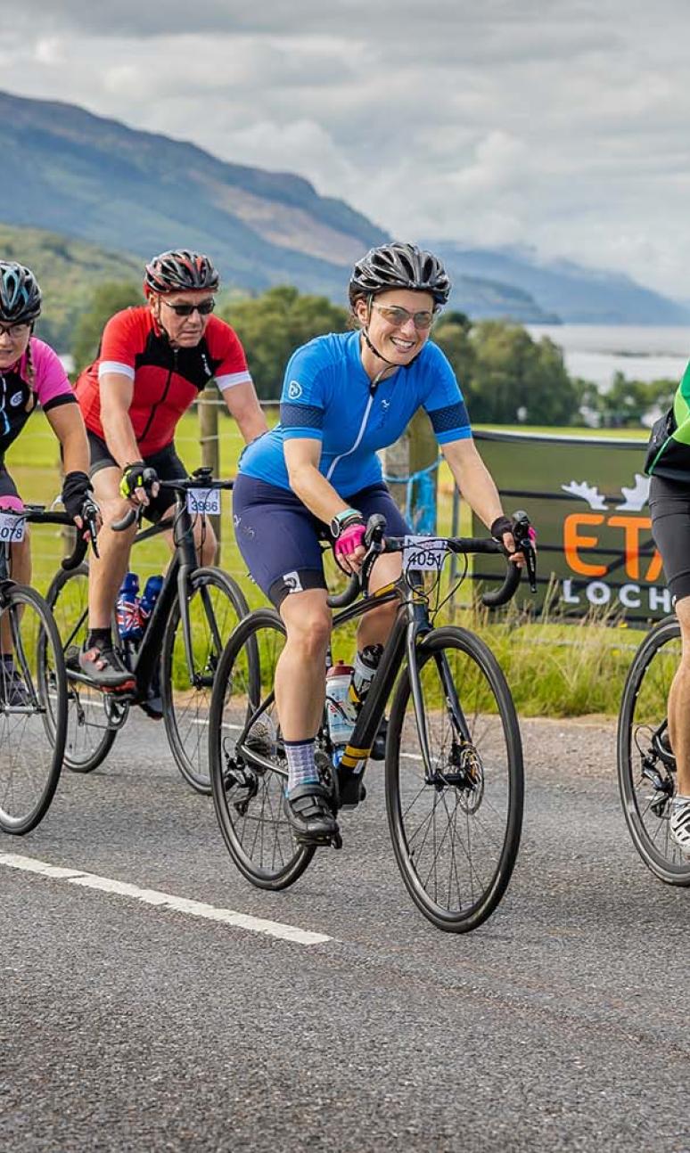 Riders smile at the camera riding along side Loch Ness