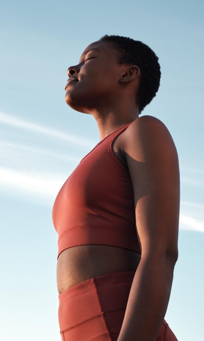 Female outdoors training underneath blue skies