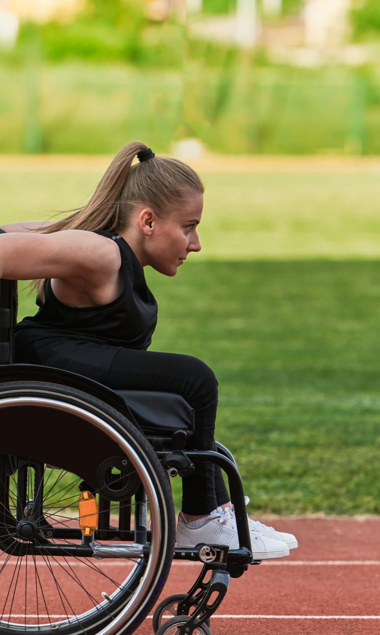 A wheelchair user enjoys an outdoor track session