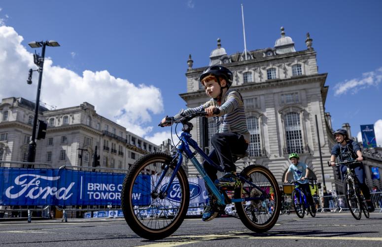 Young boy cycling at the free cycle event in central London.