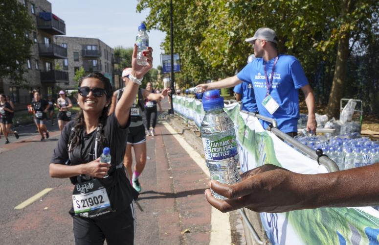 Big Half participants pass a drinks station 