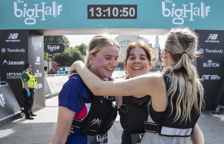 Big Half participants celebrate by hugging at the Finish Line