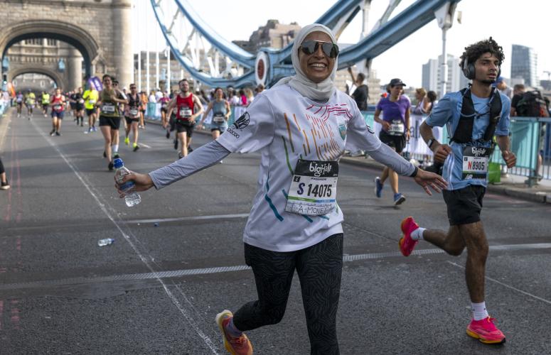 Big Half participants celebrate as they cross Tower Bridge