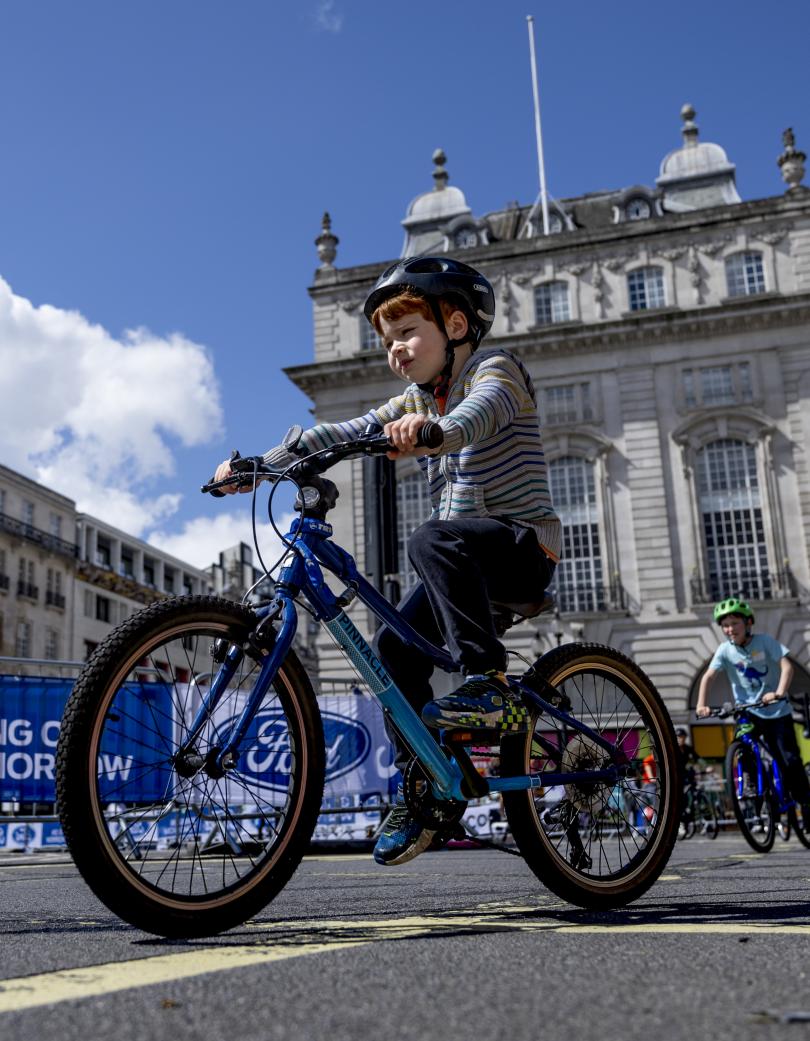 Young boy cycling at the free cycle event in central London.