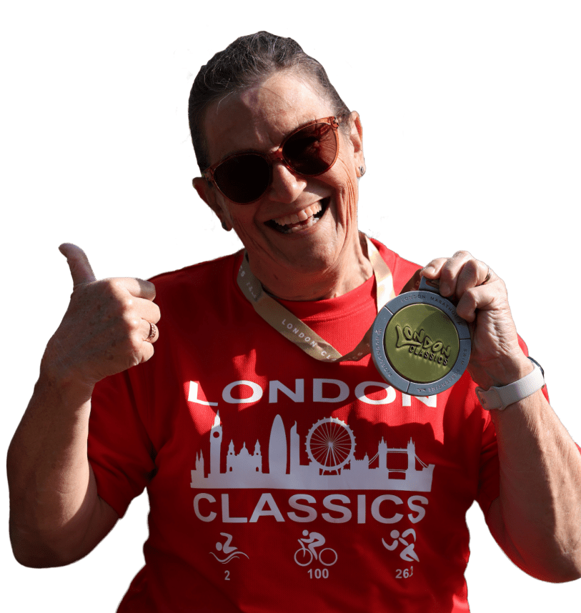 Woman holding thumbs up and medal