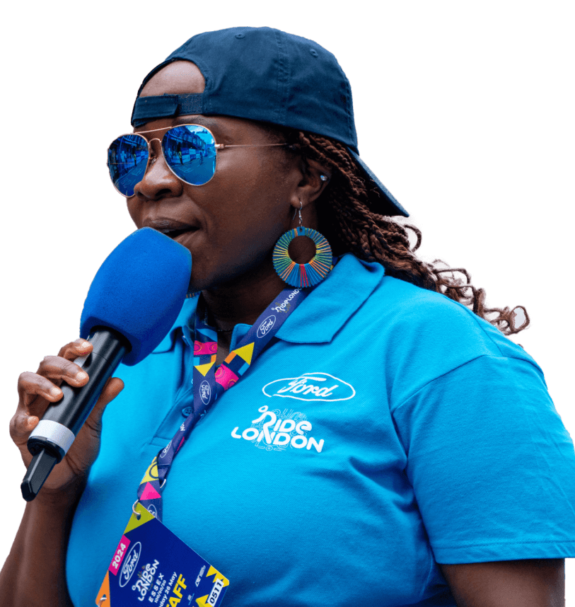 A RideLondon volunteer cheers on the riders using a microphone