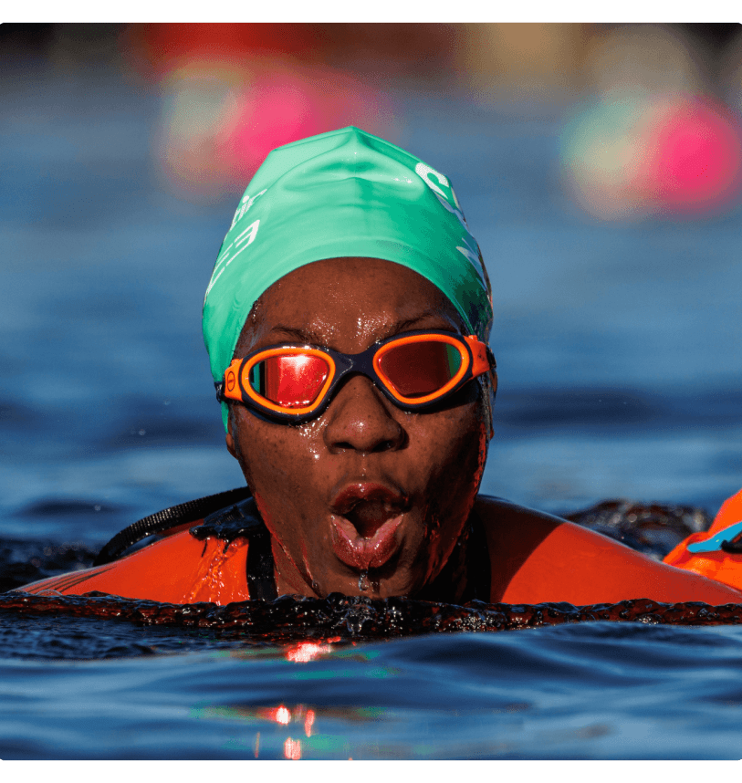 A swimmer emerges from the water during Swim Serpentine