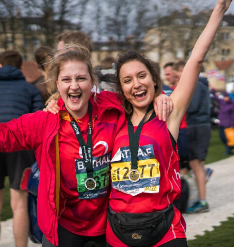 Two participants pose with their medals after their race