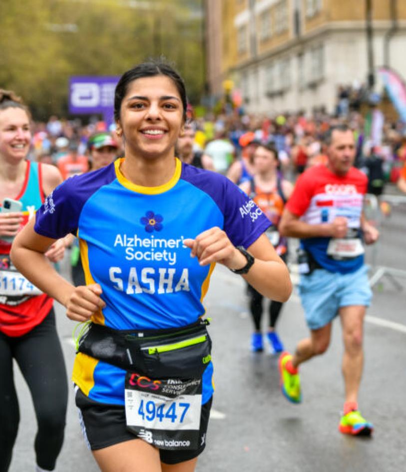 An Alzheimer's Society runner smiles at the camera during their event