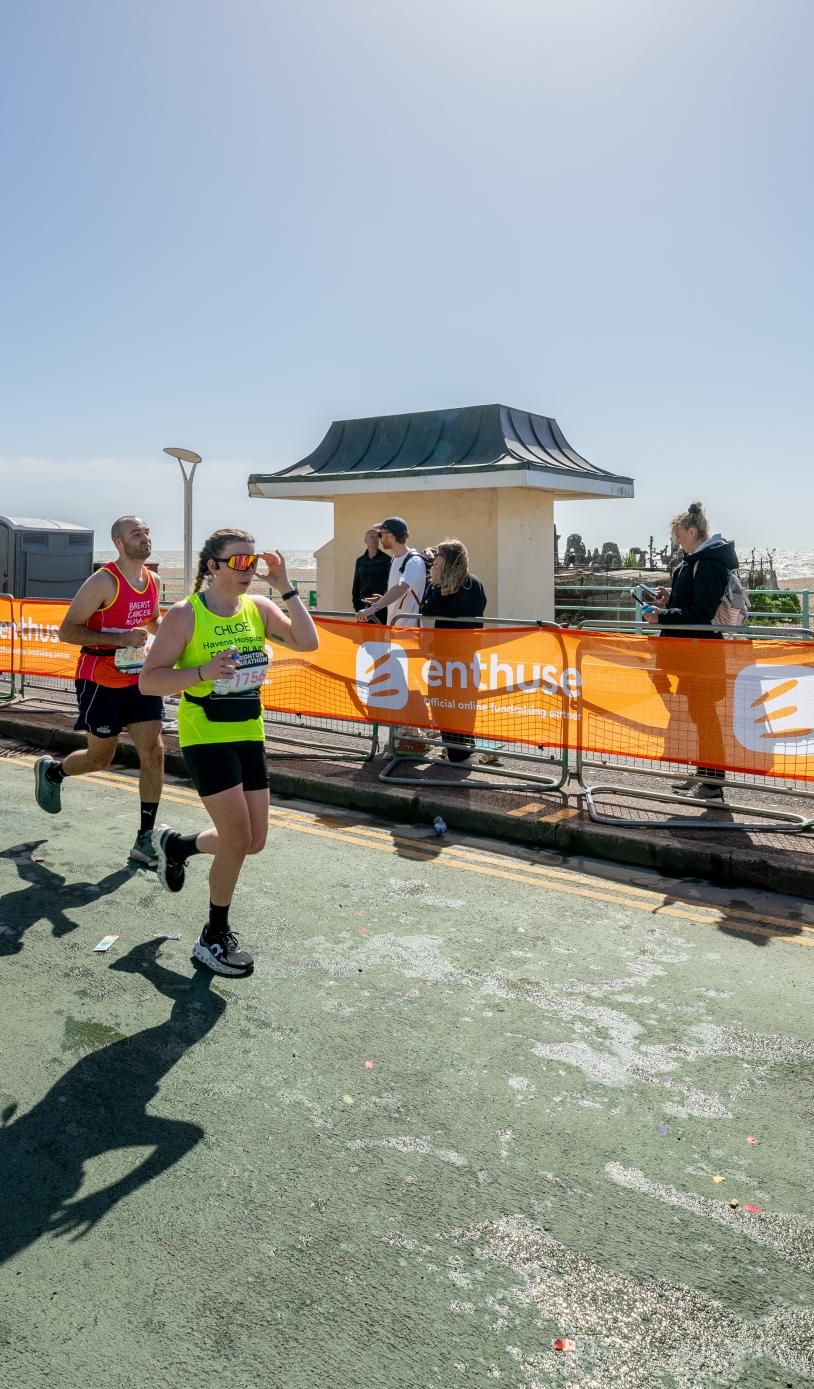 Runners run down a road in Brighton during the marathon