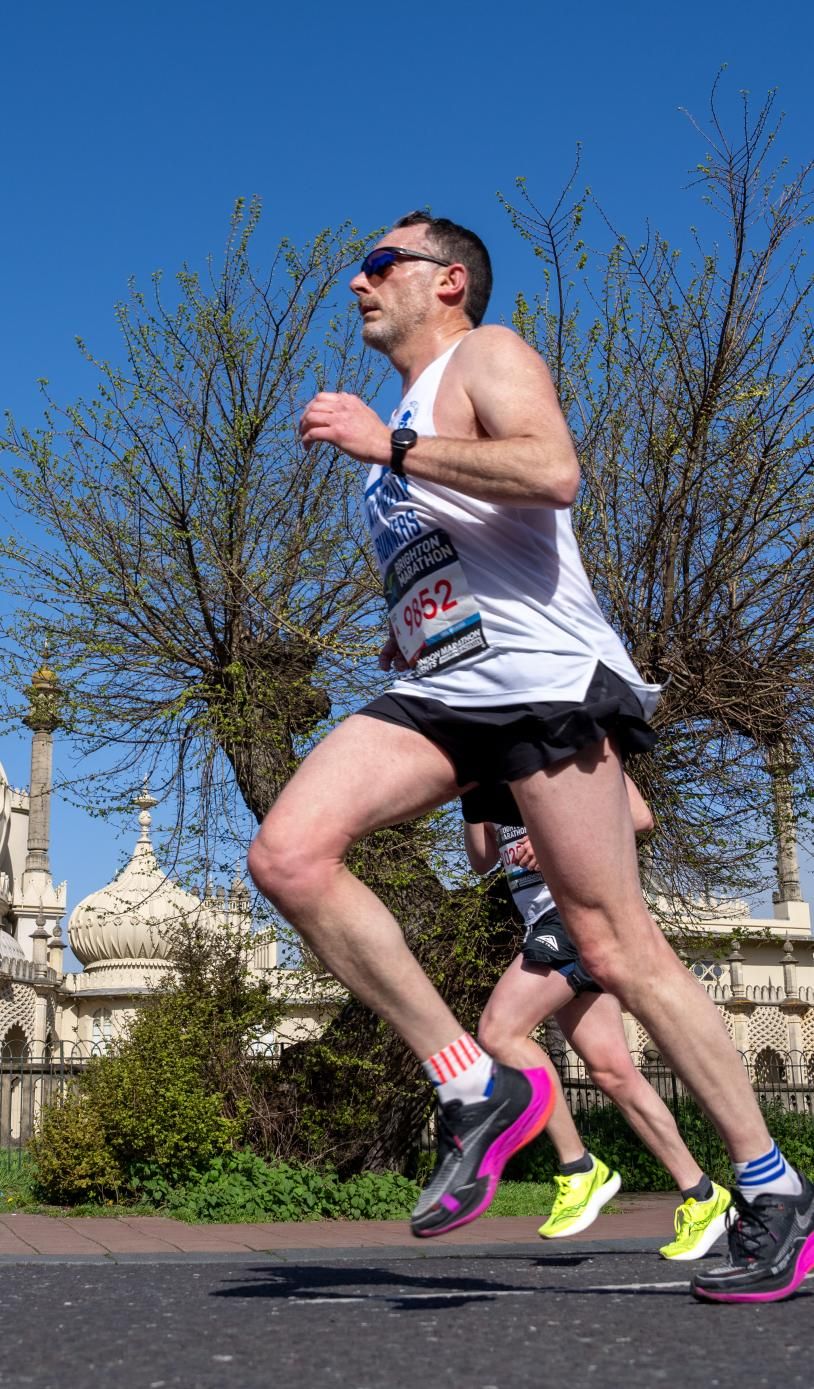 Runners run past the Brighton Pavilion 