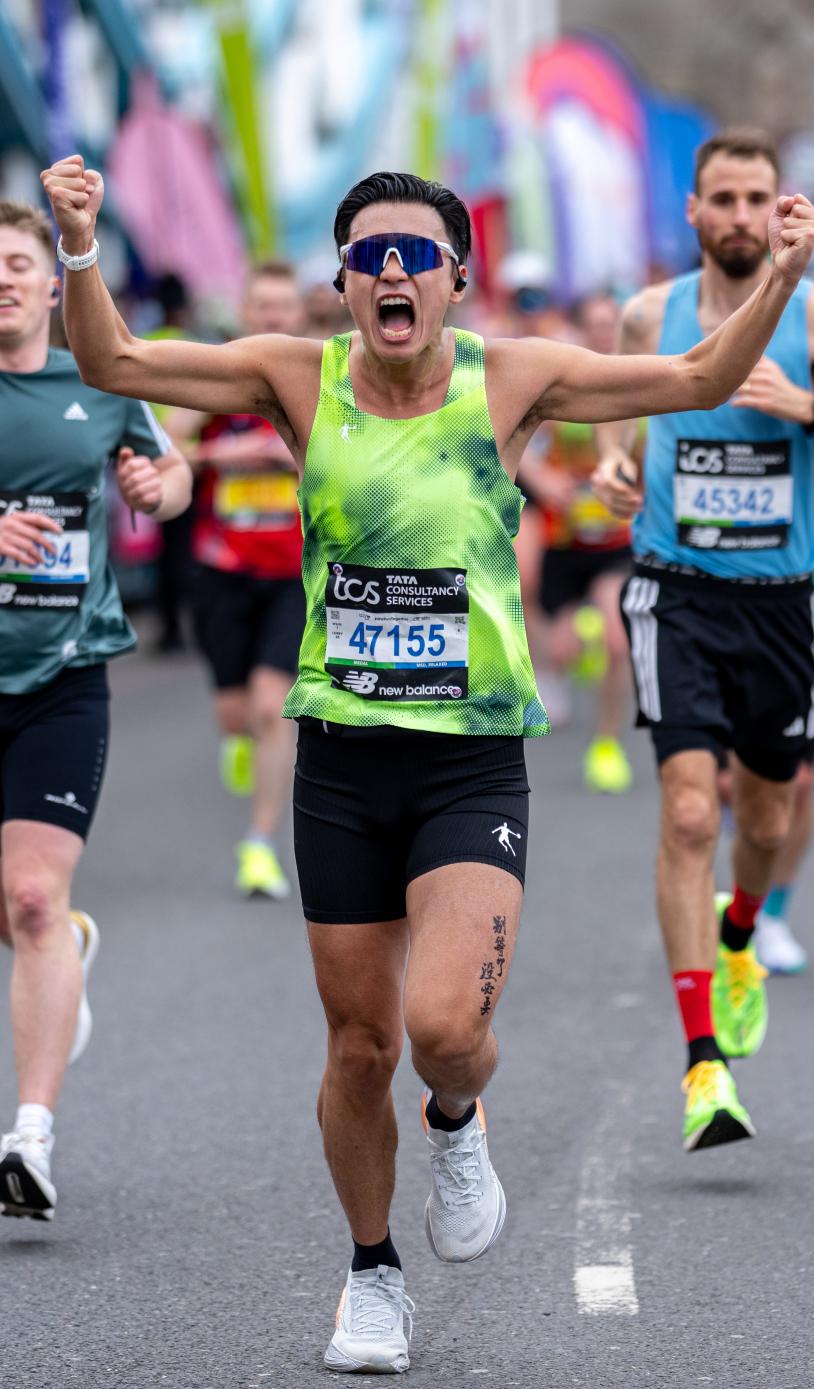 Man running with arms out celebrating