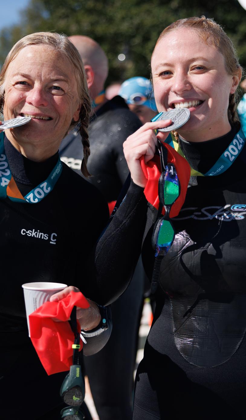 Swimmers celebrate collecting their medals after Swim Serpentine