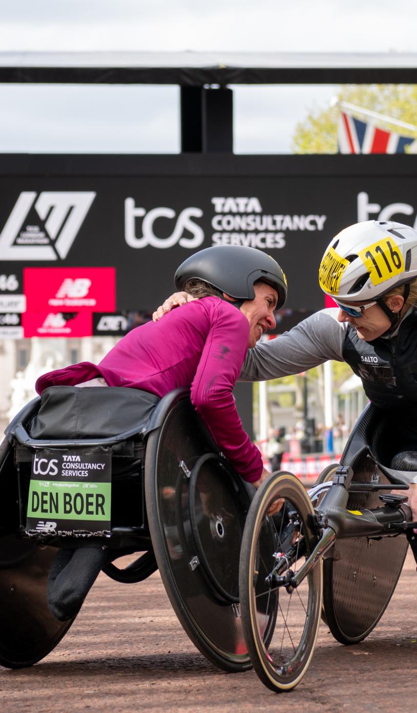 Nikita den Boer embraces Catherine Debrunner at the Finish Line on The Mall after completing the Elite Women’s Wheelchair Race