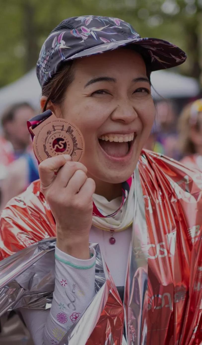 A participant poses with their medal after their event