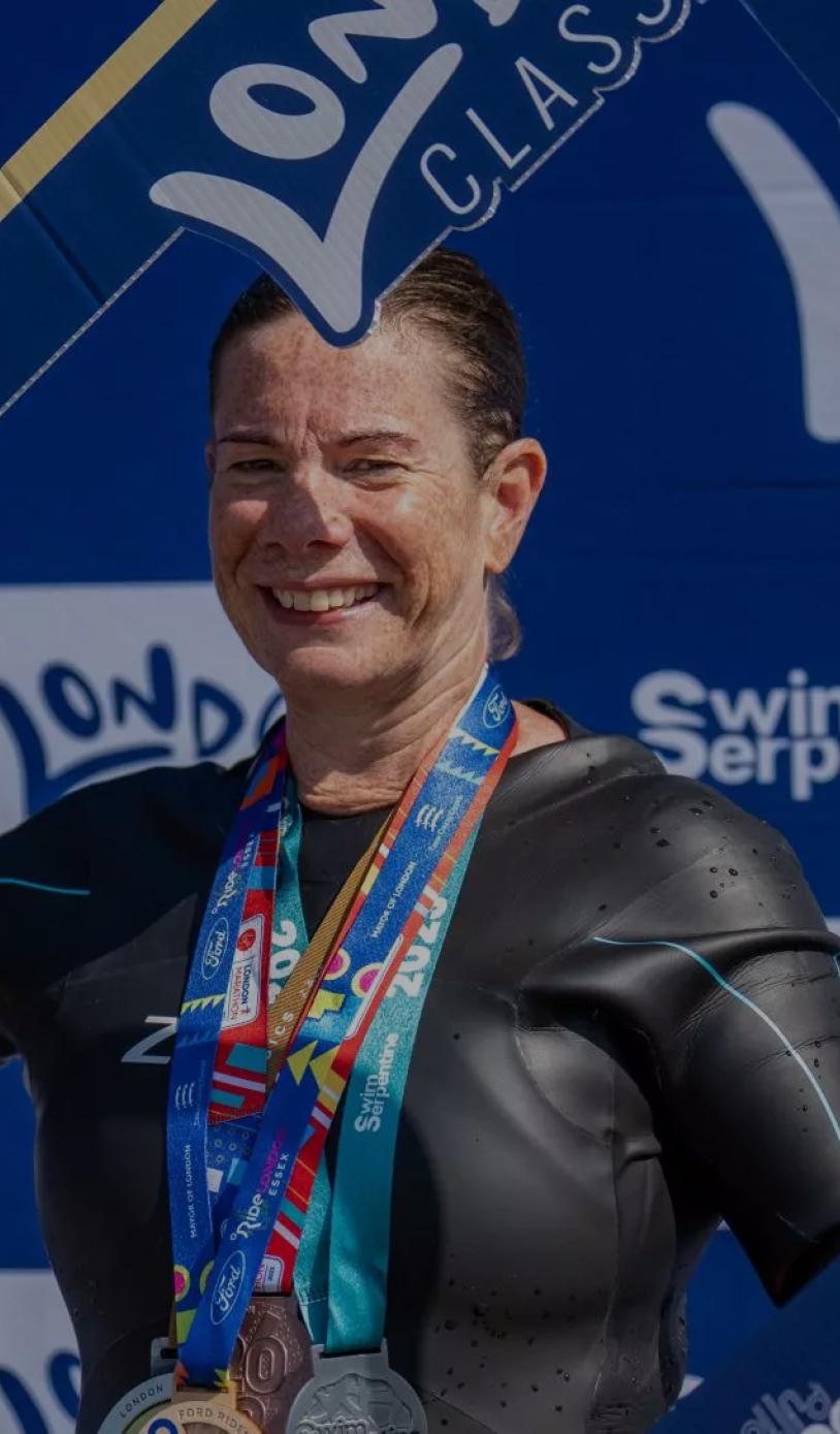 A London Classics finisher poses with a selfie frame at Swim Serpenitne