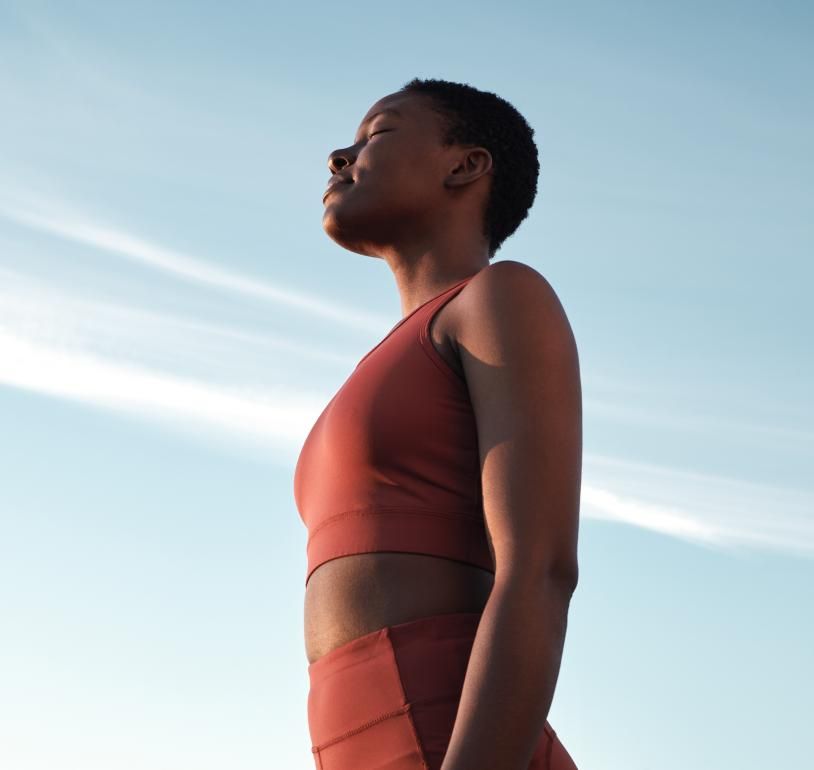 A woman training outside under blue skies