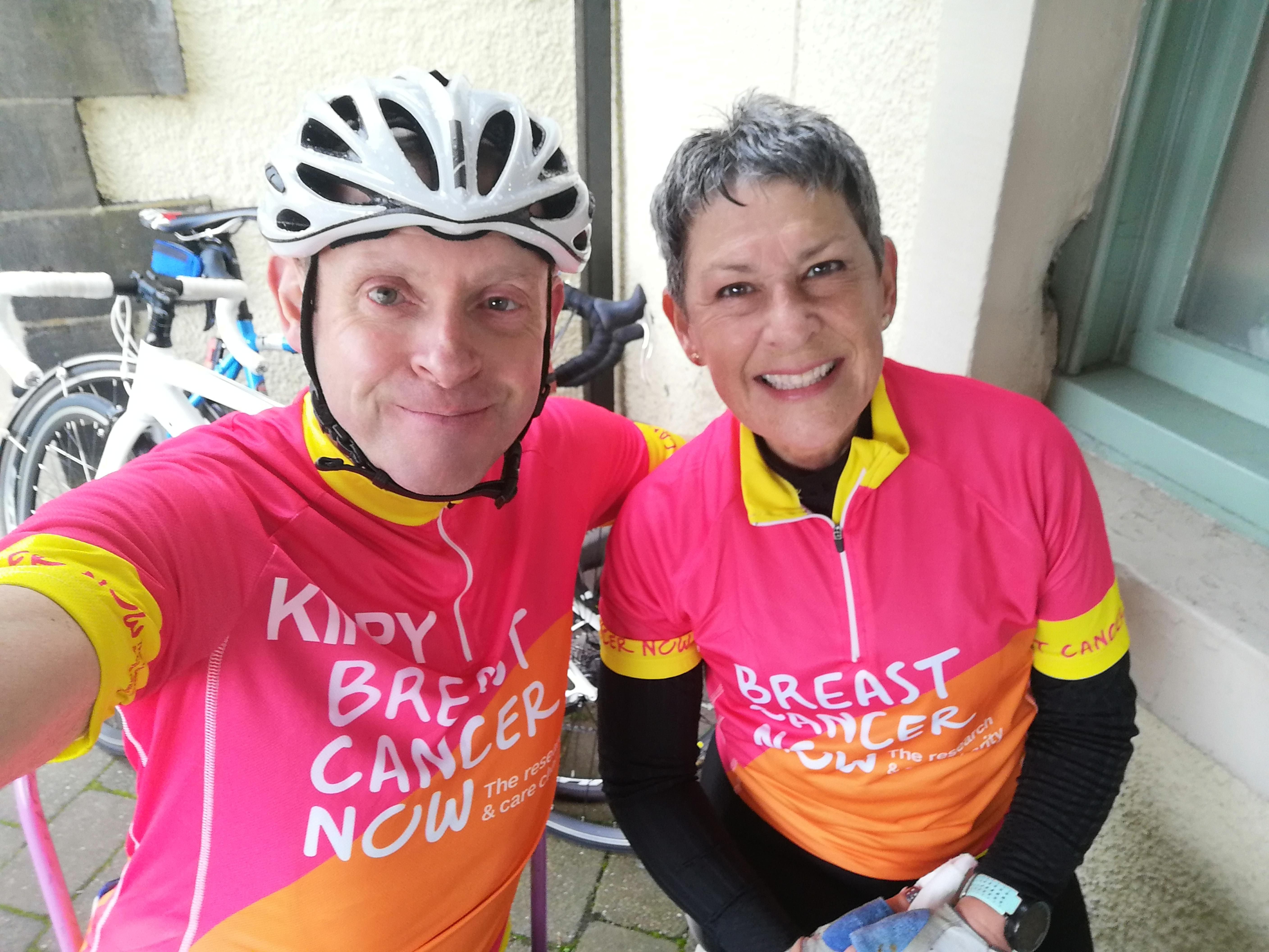 Two people smiling in cycling kit